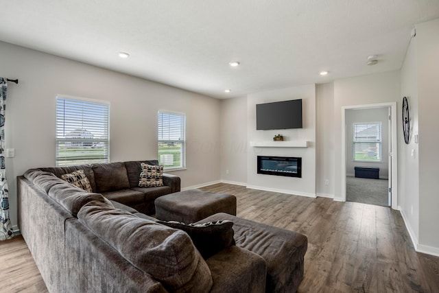 1002 Leslie Dr, Plain City, OH 43064 - living room featuring wood finished floors, a glass covered fireplace, baseboards, and recessed lighting