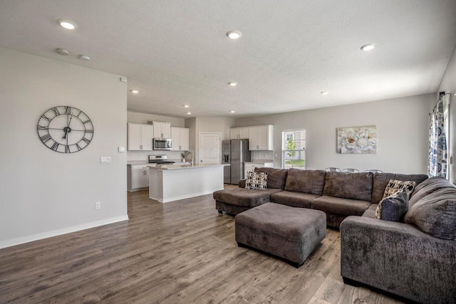 1002 Leslie Dr, Plain City, OH 43064 - living area featuring wood finished floors, recessed lighting, and baseboards