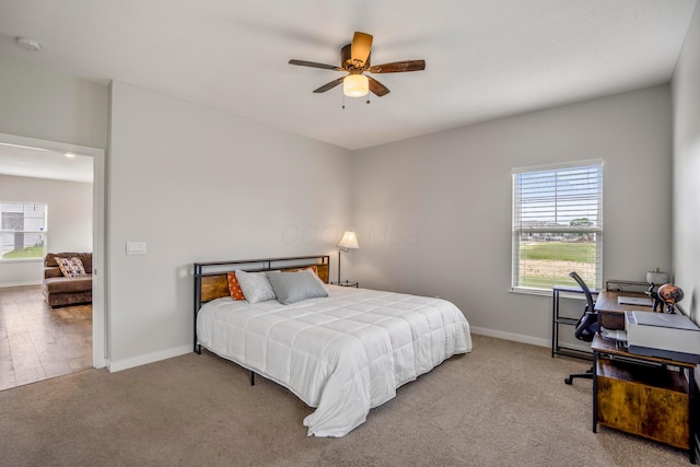 1002 Leslie Dr, Plain City, OH 43064 - carpeted bedroom featuring multiple windows, baseboards, and a ceiling fan
