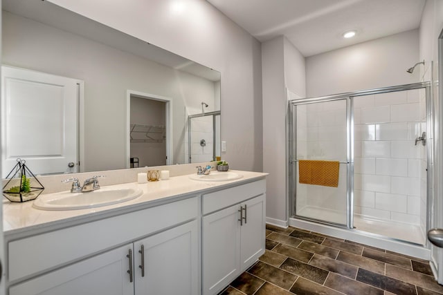 1002 Leslie Dr, Plain City, OH 43064 - bathroom with a shower stall, double vanity, a walk in closet, and recessed lighting