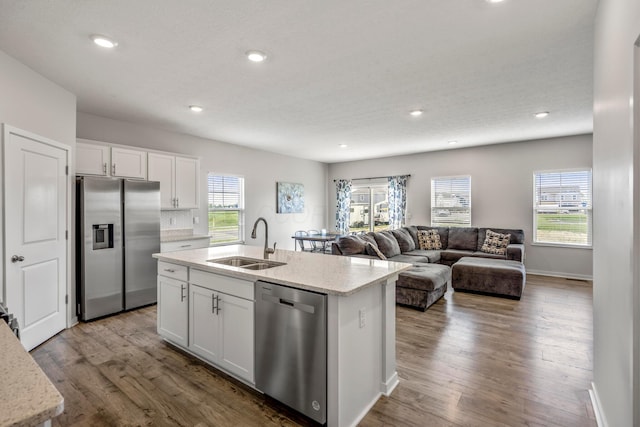 1002 Leslie Dr, Plain City, OH 43064 - kitchen featuring stainless steel appliances, a sink, white cabinets, plenty of natural light, and recessed lighting