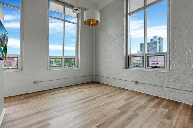 60 E Spring St Unit 327, Columbus, OH 43215 - empty room with brick wall and light wood-type flooring