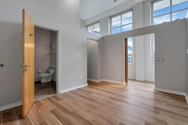 60 E Spring St Unit 327, Columbus, OH 43215 - spare room with light wood-type flooring, a high ceiling, and baseboards
