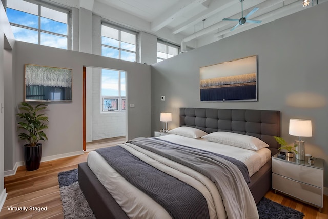 60 E Spring St Unit 327, Columbus, OH 43215 - bedroom featuring beam ceiling, a high ceiling, and wood finished floors