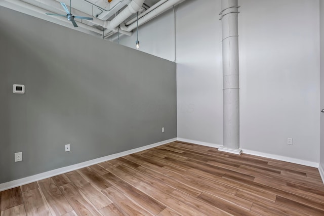 60 E Spring St Unit 327, Columbus, OH 43215 - empty room featuring wood finished floors, ceiling fan, and baseboards