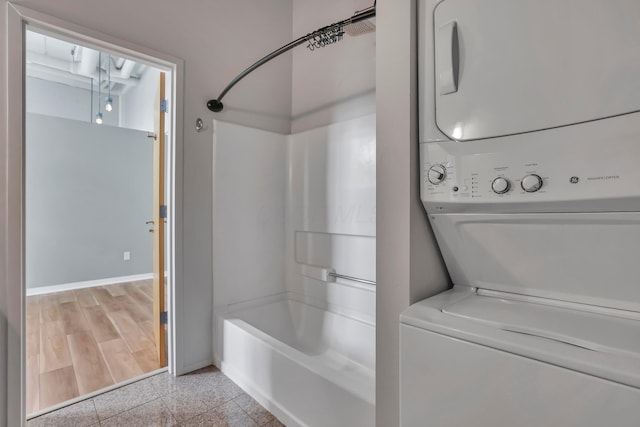 60 E Spring St Unit 327, Columbus, OH 43215 - bathroom with baseboards, stacked washer and clothes dryer, shower / bath combination, and granite tiled floors