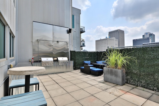 60 E Spring St Unit 327, Columbus, OH 43215 - view of patio / terrace featuring a city view, a grill, and a balcony