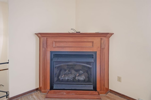 299 Sherwood Downs S, Newark, OH 43055 - detailed view of wood finished floors, baseboards, and a fireplace
