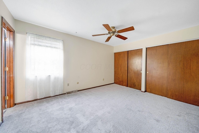 299 Sherwood Downs S, Newark, OH 43055 - unfurnished bedroom with multiple closets, carpet, and ceiling fan
