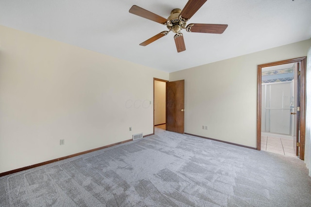 299 Sherwood Downs S, Newark, OH 43055 - unfurnished bedroom featuring light carpet, baseboards, connected bathroom, and a ceiling fan