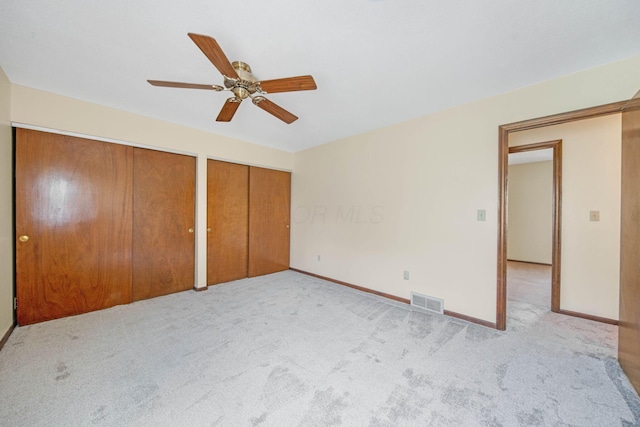 299 Sherwood Downs S, Newark, OH 43055 - unfurnished bedroom featuring carpet, two closets, baseboards, and ceiling fan