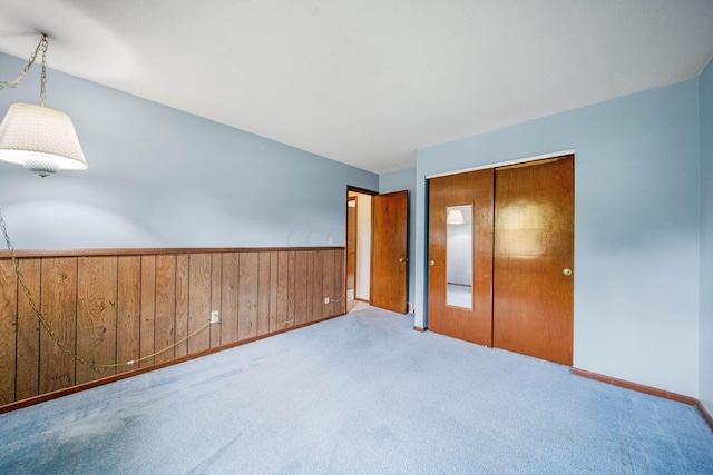299 Sherwood Downs S, Newark, OH 43055 - unfurnished bedroom with carpet, wooden walls, a closet, wainscoting, and baseboards
