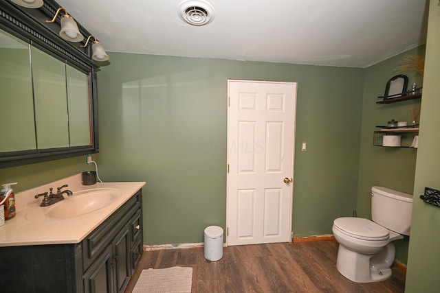 6566 S St, Marion, OH 43302 - bathroom with wood finished floors, toilet, vanity, and baseboards
