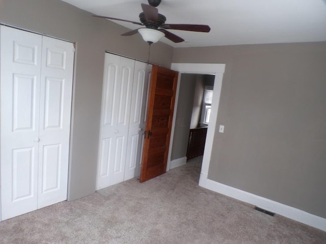 905-907 Beech St, Columbus, OH 43206 - unfurnished bedroom with carpet, multiple closets, and a ceiling fan