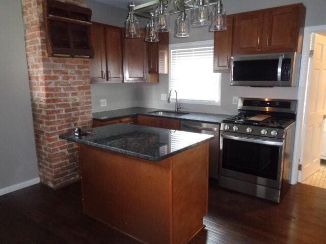 905-907 Beech St, Columbus, OH 43206 - kitchen with appliances with stainless steel finishes, a sink, dark wood finished floors, a kitchen island, and dark stone counters