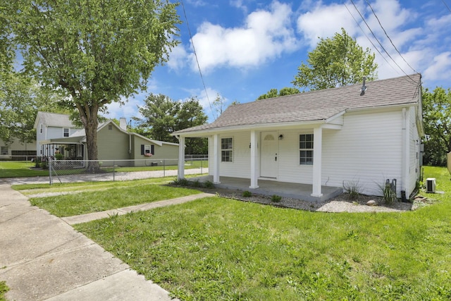 663 E Mound St, Circleville, OH 43113 - view of front of home with covered porch, central AC unit, and roof with shingles