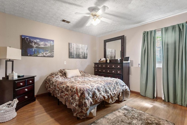 6799 Thrasher Ct, Orient, OH 43146 - bedroom with wood finished floors, a textured ceiling, baseboards, and a ceiling fan