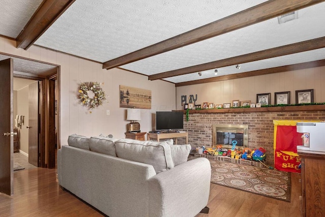 6799 Thrasher Ct, Orient, OH 43146 - living room featuring wood finished floors, beamed ceiling, a textured ceiling, and wood walls
