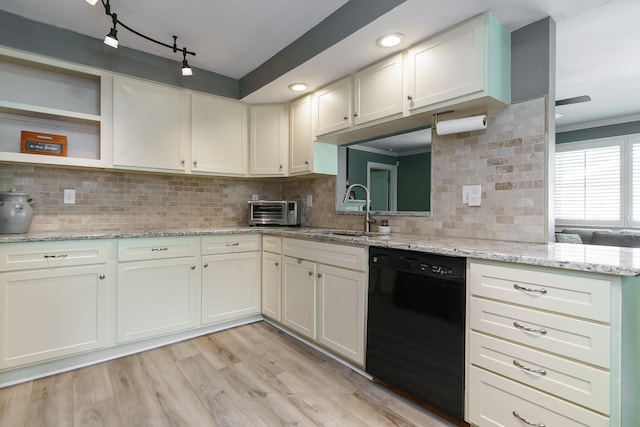 542 Blenheim Rd, Columbus, OH 43214 - kitchen with black dishwasher, a sink, backsplash, light wood-style flooring, and crown molding