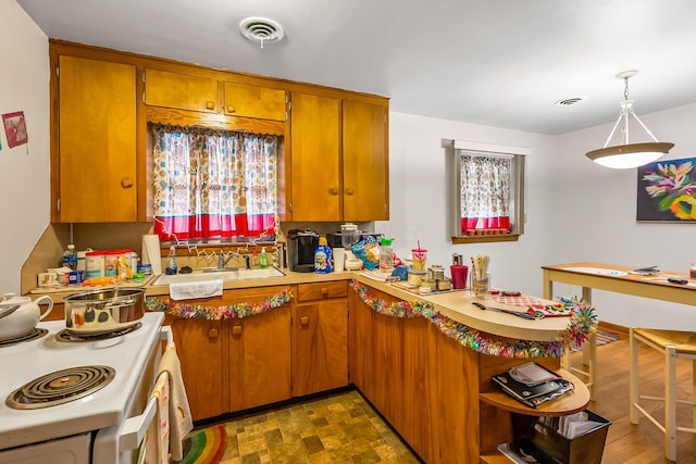 320 N 3rd St, Coshocton, OH 43812 - kitchen with electric range, a peninsula, brown cabinetry, light countertops, and open shelves