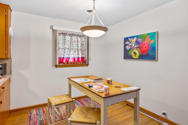 320 N 3rd St, Coshocton, OH 43812 - dining area featuring light wood-style flooring and baseboards