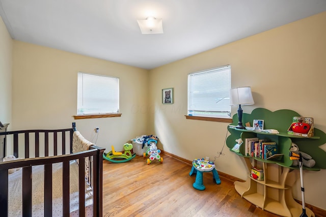320 N 3rd St, Coshocton, OH 43812 - bedroom with multiple windows, wood finished floors, and baseboards