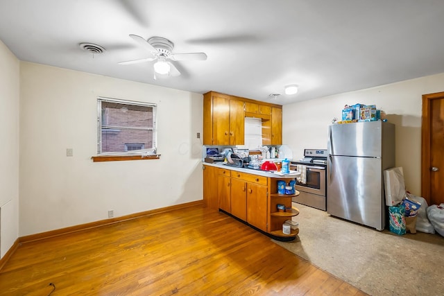 320 N 3rd St, Coshocton, OH 43812 - kitchen with stainless steel appliances, a peninsula, a ceiling fan, open shelves, and light countertops