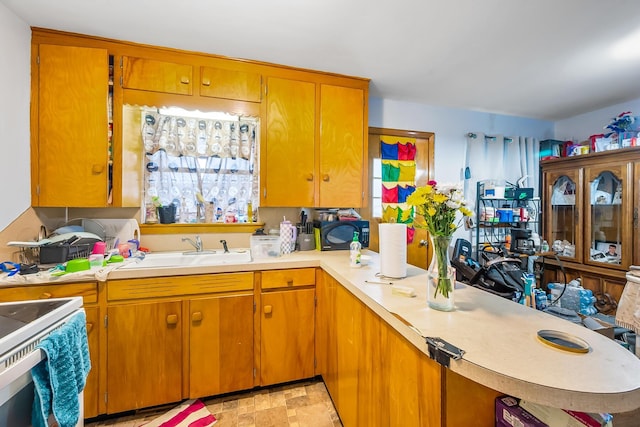 320 N 3rd St, Coshocton, OH 43812 - kitchen featuring light countertops, a sink, electric stove, and brown cabinets