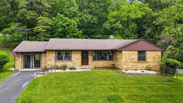 1244 N Broad St, Lancaster, OH 43130 - ranch-style house with brick siding, a front lawn, a chimney, and a shingled roof