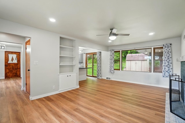 1244 N Broad St, Lancaster, OH 43130 - unfurnished living room featuring a ceiling fan, a fireplace with raised hearth, light wood finished floors, baseboards, and recessed lighting