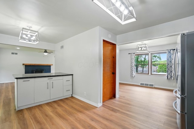 1244 N Broad St, Lancaster, OH 43130 - kitchen with freestanding refrigerator, white cabinetry, dark countertops, and light wood-style flooring