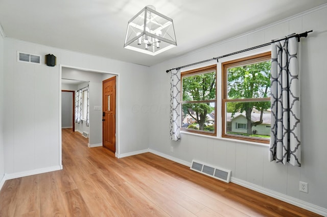1244 N Broad St, Lancaster, OH 43130 - unfurnished room featuring light wood-style flooring, a chandelier, baseboards, and crown molding