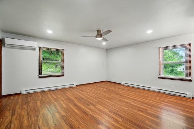 1244 N Broad St, Lancaster, OH 43130 - spare room featuring a baseboard heating unit, a wall mounted AC, healthy amount of natural light, and recessed lighting
