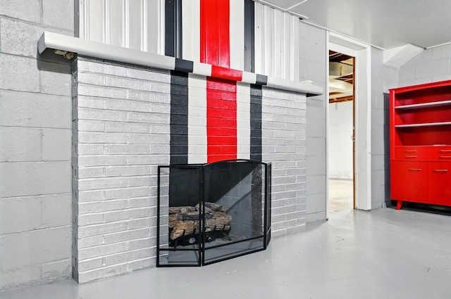 1244 N Broad St, Lancaster, OH 43130 - detailed view of concrete block wall, finished concrete flooring, and a brick fireplace