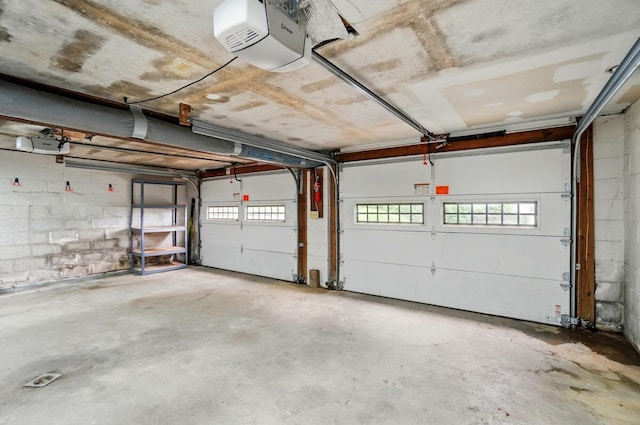1244 N Broad St, Lancaster, OH 43130 - garage featuring a garage door opener and concrete block wall