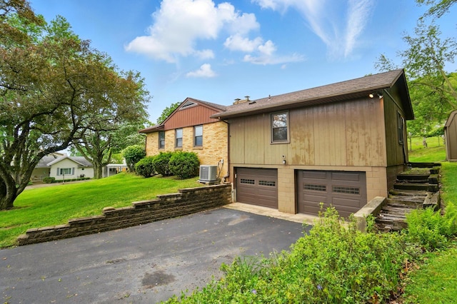 1244 N Broad St, Lancaster, OH 43130 - view of home's exterior with central air condition unit, driveway, a yard, and an attached garage