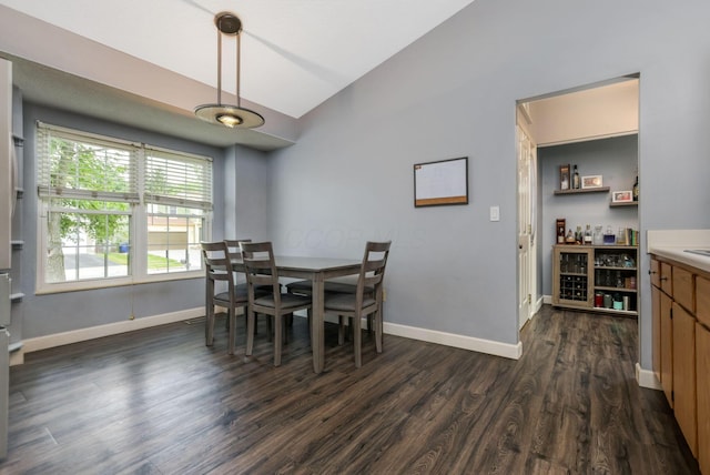 1790 Jupiter Ave, Hilliard, OH 43026 - dining room featuring lofted ceiling, dark wood-style flooring, baseboards, and a bar
