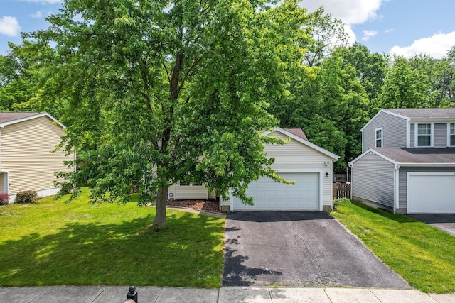 1790 Jupiter Ave, Hilliard, OH 43026 - view of front facade with asphalt driveway, a front yard, and a garage