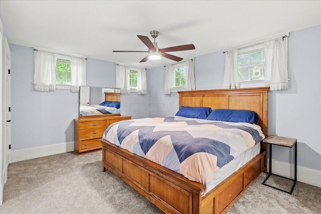 261 E Sandusky St, Mechanicsburg, OH 43044 - bedroom with light colored carpet, multiple windows, baseboards, and ceiling fan