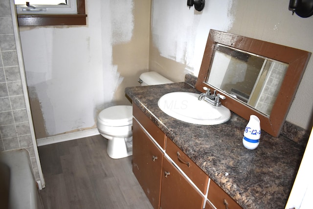 54 2nd St, Shelby, OH 44875 - full bath with toilet, wood finished floors, a shower, vanity, and a tub to relax in