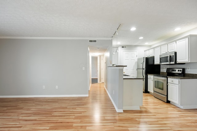 5373 Cypress Chase, Columbus, OH 43228 - kitchen featuring appliances with stainless steel finishes, dark countertops, light wood-type flooring, a textured ceiling, and white cabinets