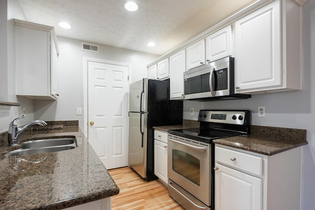 5373 Cypress Chase, Columbus, OH 43228 - kitchen with stainless steel appliances, a sink, dark countertops, white cabinets, and recessed lighting