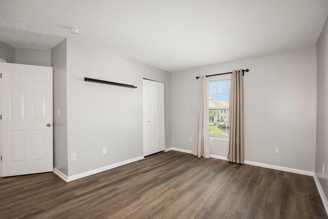 5373 Cypress Chase, Columbus, OH 43228 - unfurnished bedroom with dark wood finished floors, baseboards, a closet, and a textured ceiling