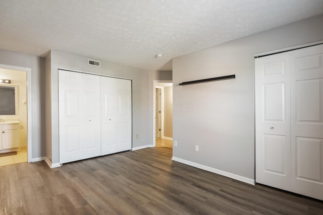 5373 Cypress Chase, Columbus, OH 43228 - unfurnished bedroom with wood finished floors, baseboards, a textured ceiling, and ensuite bathroom