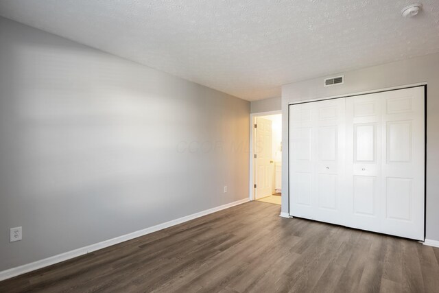 5373 Cypress Chase, Columbus, OH 43228 - unfurnished bedroom with dark wood-style floors, baseboards, a closet, and a textured ceiling