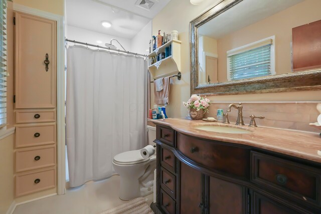 1235 Canteberry Ln, Mansfield, OH 44906 - bathroom featuring vanity, toilet, a shower with shower curtain, and backsplash