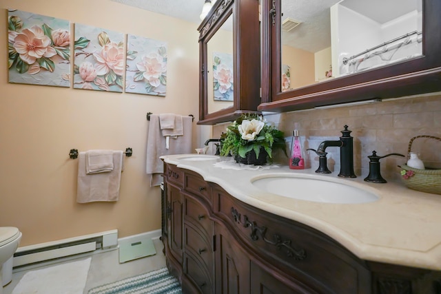1235 Canteberry Ln, Mansfield, OH 44906 - full bath with baseboard heating, decorative backsplash, double vanity, toilet, and baseboards