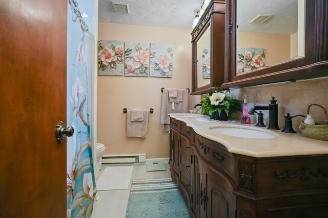 1235 Canteberry Ln, Mansfield, OH 44906 - bathroom with double vanity, a textured ceiling, baseboard heating, decorative backsplash, and toilet