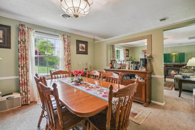 1235 Canteberry Ln, Mansfield, OH 44906 - dining room featuring crown molding, light carpet, a glass covered fireplace, and baseboards