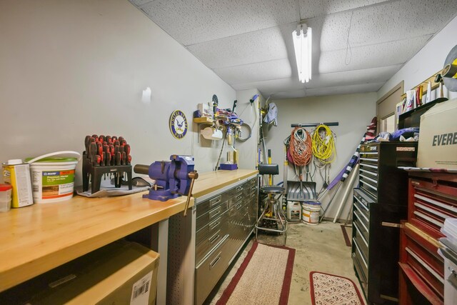 1235 Canteberry Ln, Mansfield, OH 44906 - miscellaneous room featuring a paneled ceiling, unfinished concrete flooring, and a workshop area